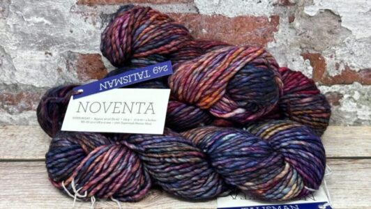 A photo of three skeins of Malabrigo yarn in Talisman