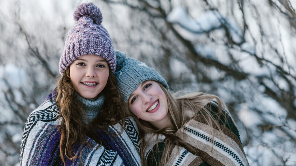 Young people wearing knitted items.
